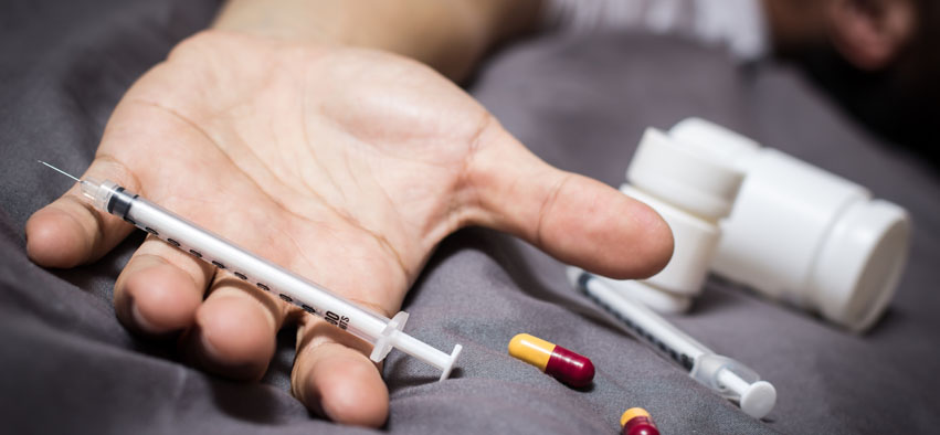 overdose asian male drug addict / syringe, drugs and narcotic