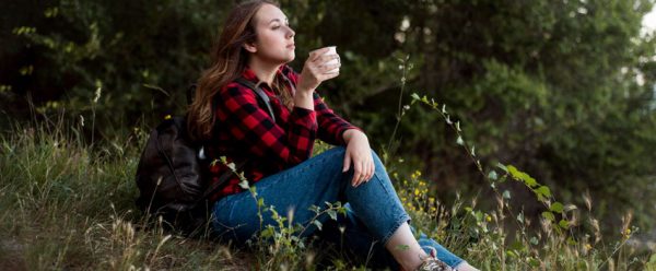 full-shot-woman-sitting-ground-forest_23-2148637099
